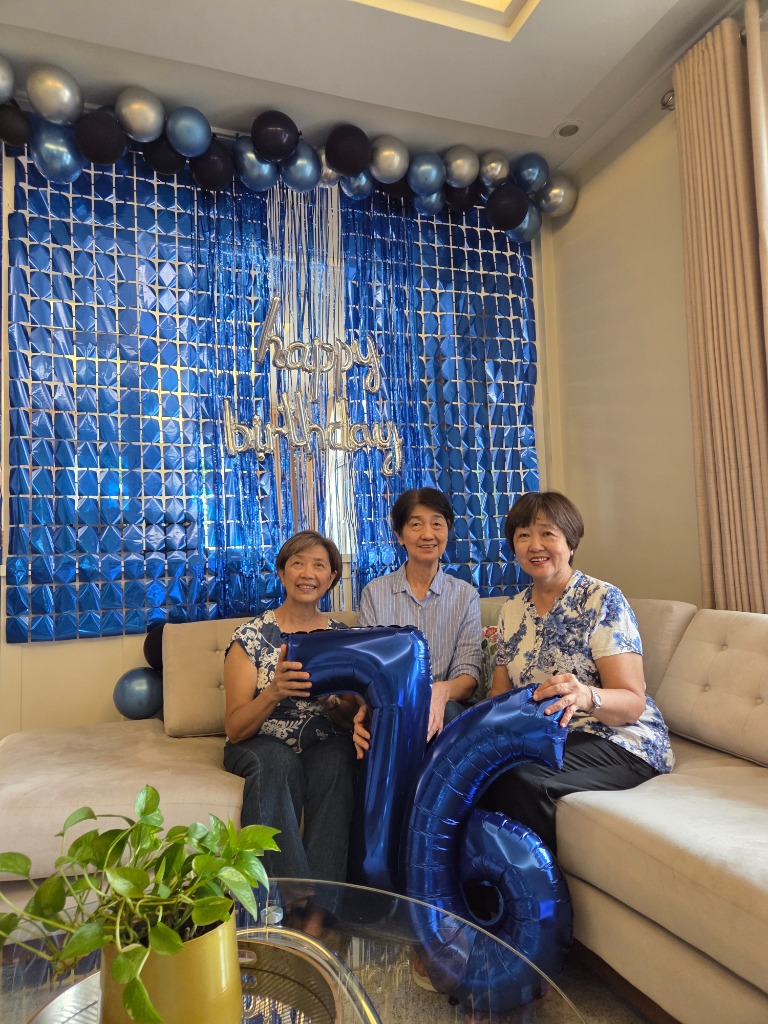 The Three Olivan Sisters Holding Blue 76 Milestone Balloons