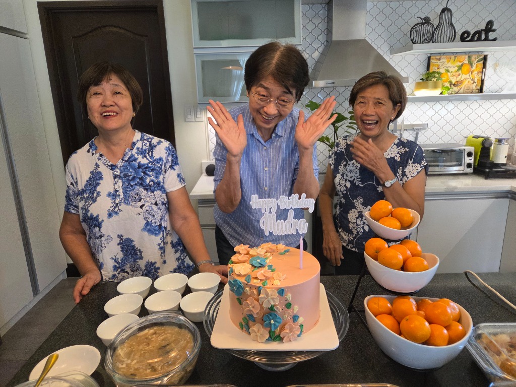 Olivan Sisters joyful reaction next to the Happy Birthday Mudra cake